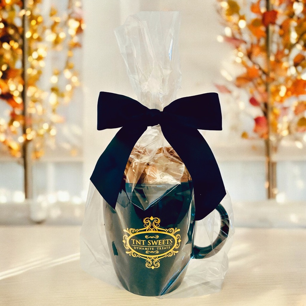 Chocolate chip cookies gift mug wrapped in cellophane and black bow.