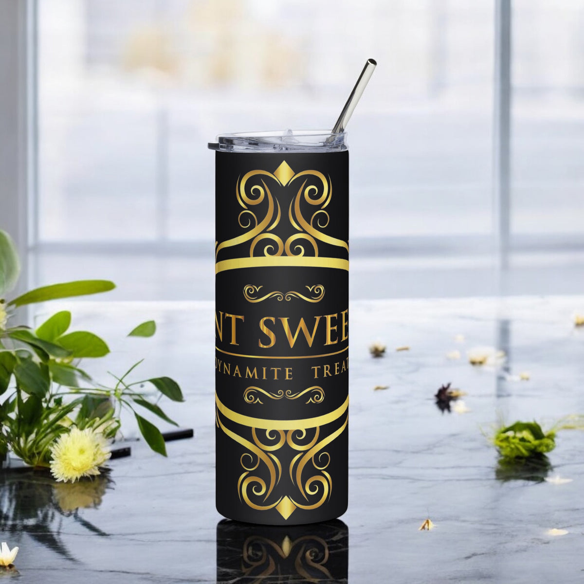 Signature 20oz tumbler with a black logo on a marble countertop with scattered spring flowers.