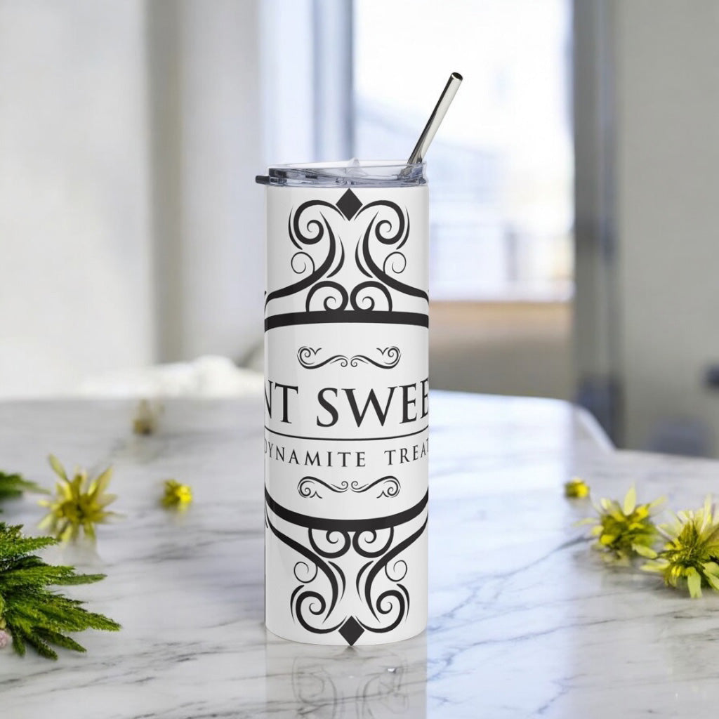 Classic white 20oz tumbler with a black logo on a marble countertop with scattered spring flowers.