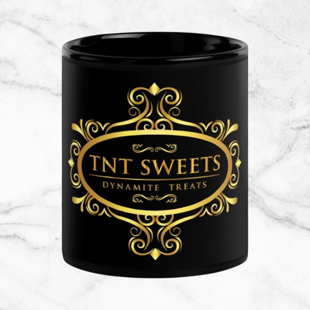 Black 11oz ceramic mug with a black logo on a white marble countertop.