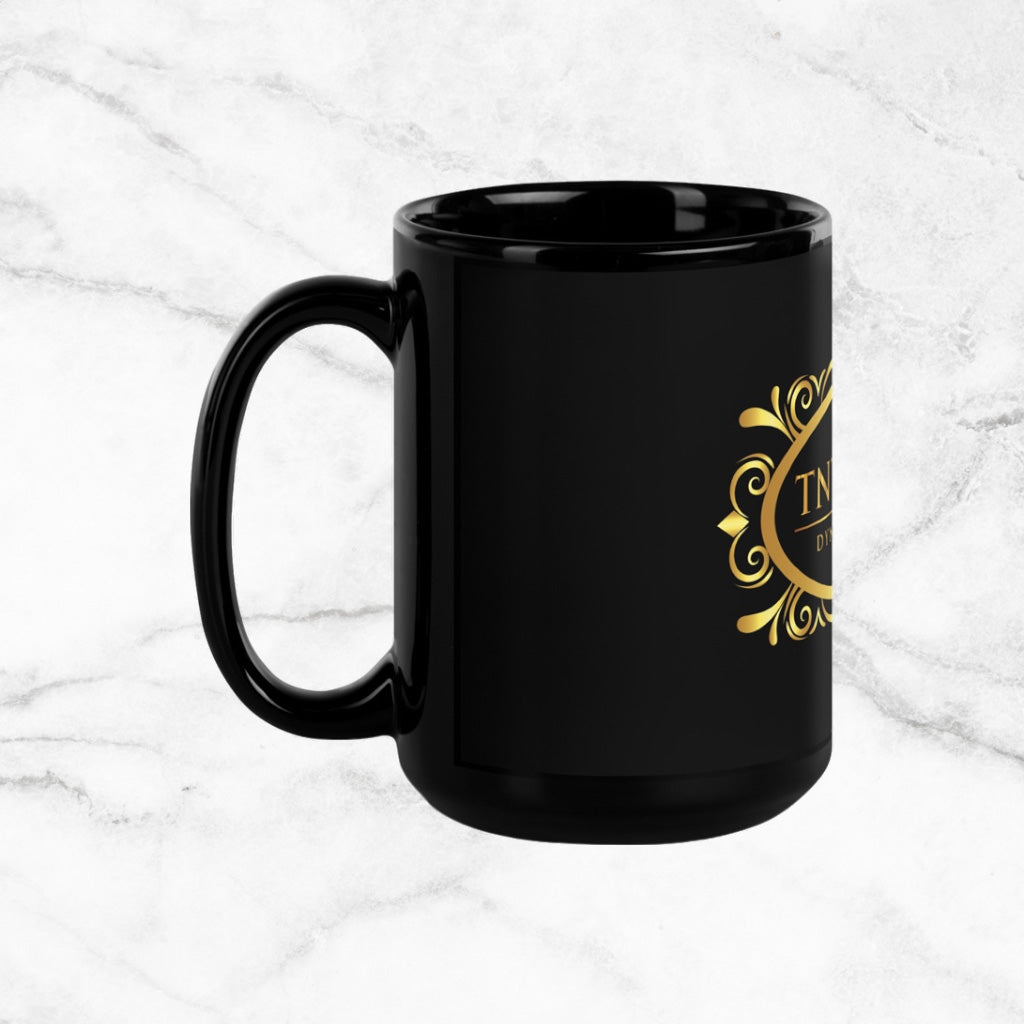 Side view Black 15oz ceramic mug with a black logo on a white marble countertop.