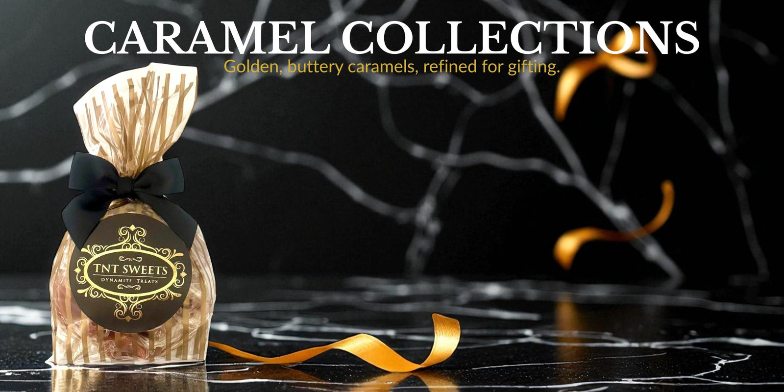 Gold striped gift bag of a half pound of caramels with decorative elements on a black marble background.