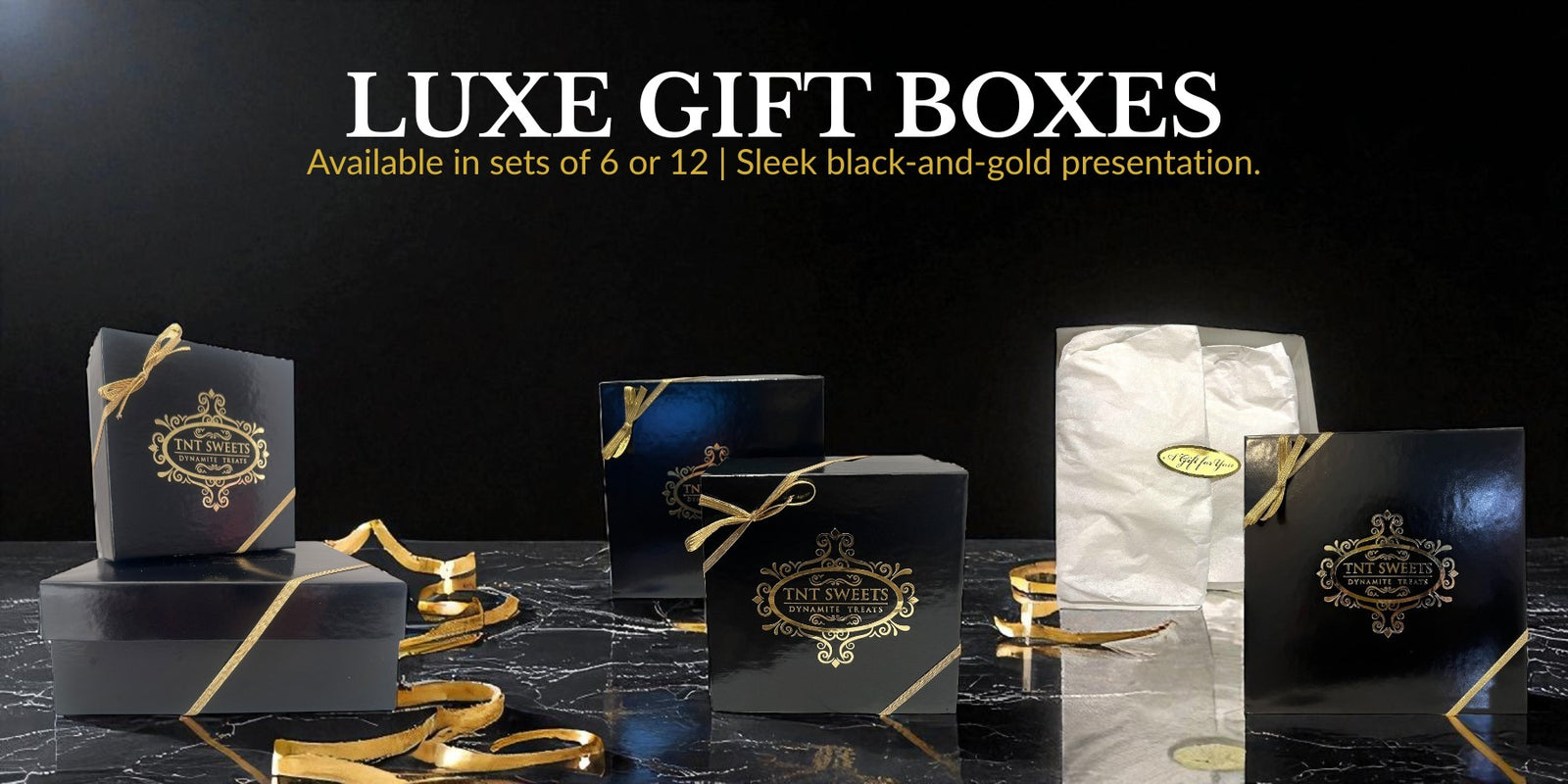 Luxe gift boxes with black and gold design on a dark surface
