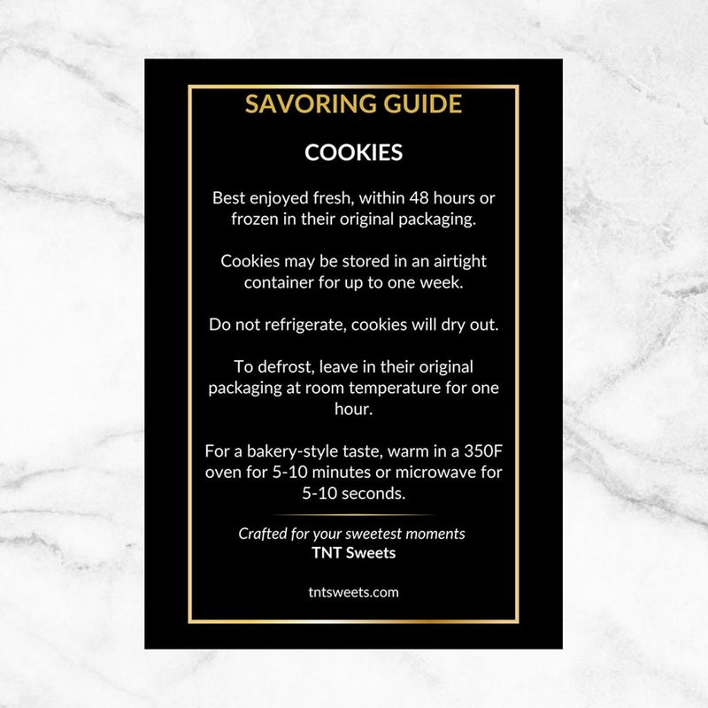 TNT Sweets Cookie Savoring Guide with serving, storage, freezing, and warming instructions, displayed on a white marble surface.