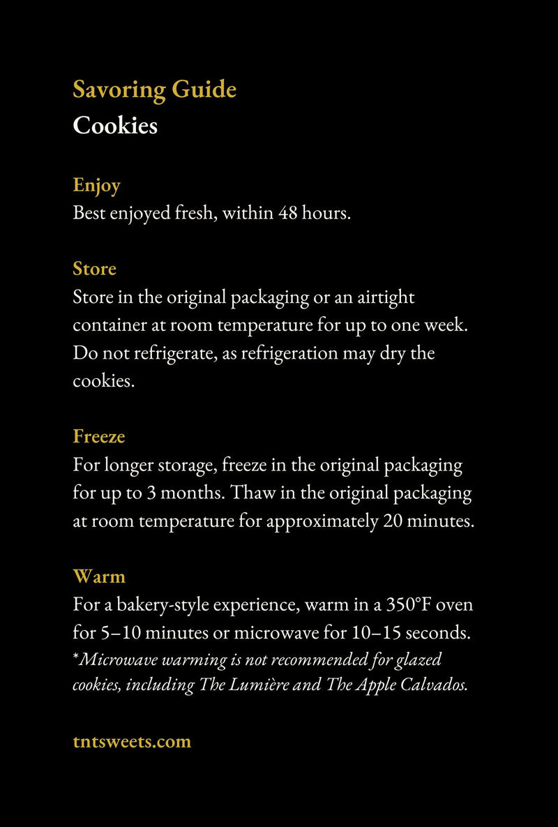 TNT Sweets Cookie Savoring Guide with serving, storage, freezing, and warming instructions, displayed on a white marble surface.