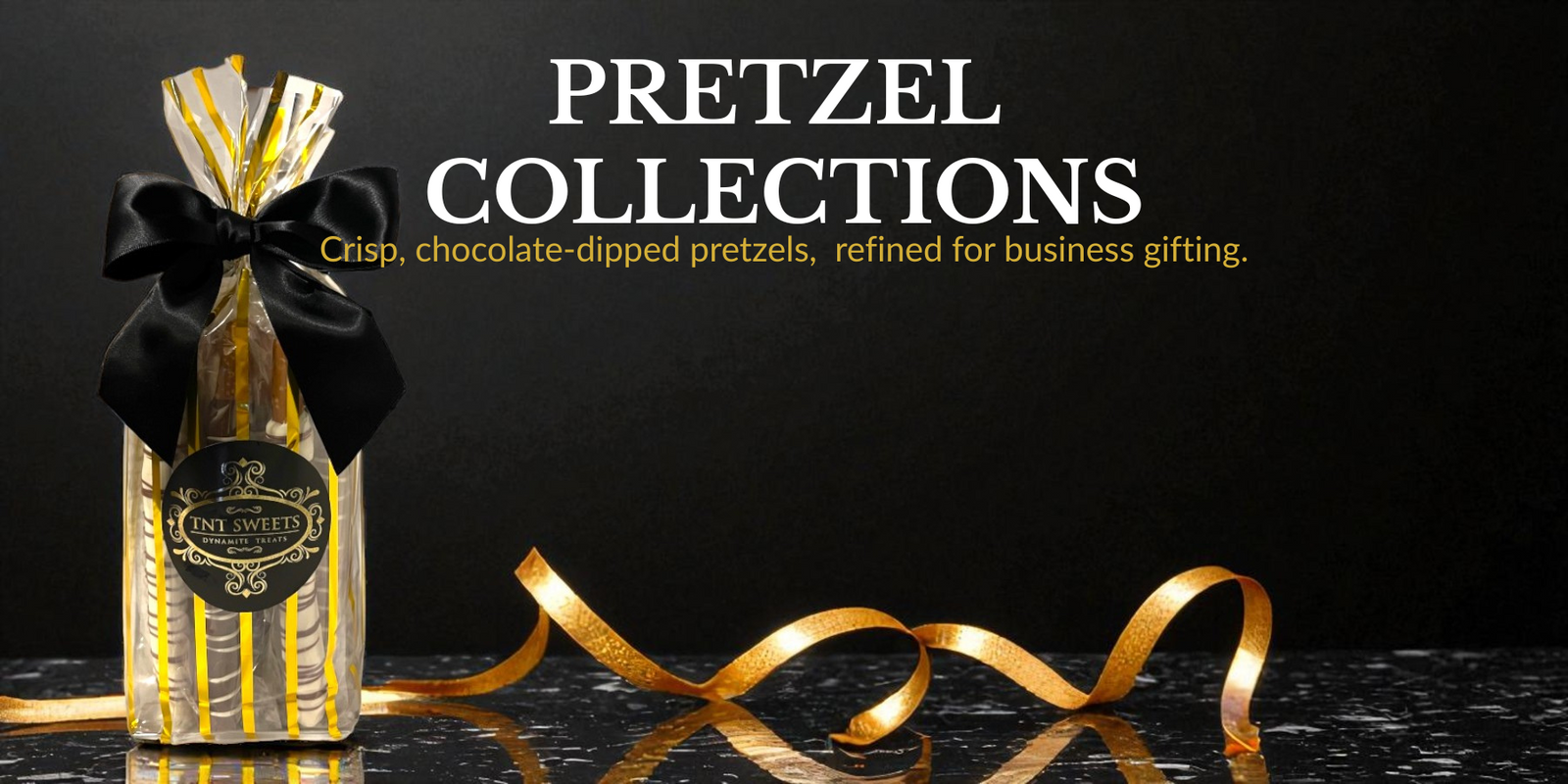 Signature gold Pretzel bottle with gold ribbon on a black background, featuring 'Pretzel Collections' text.