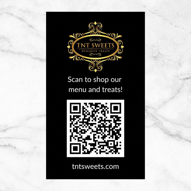 TNT Sweets digital menu card featuring a QR code to scan and shop the complete menu of handcrafted confections, displayed on a white marble surface.