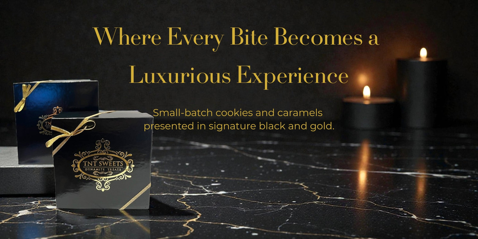 Black and gold TNT Sweets luxury cookie gift boxes displayed on marble surface with candlelight background.