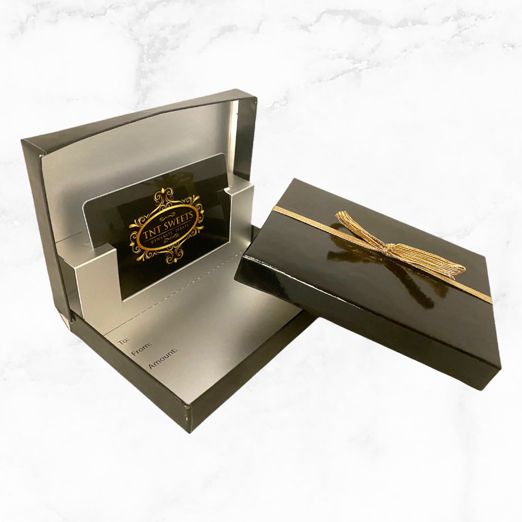Gift card enclosed in a black glossy box on a marble countertop.
