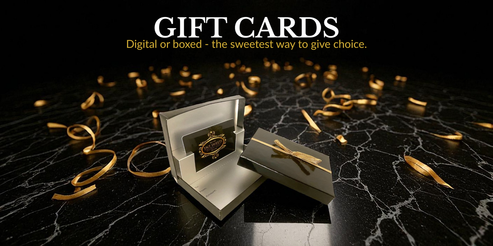 Gift card with gold ribbon on a black marble surface with 'Gift Cards' text.