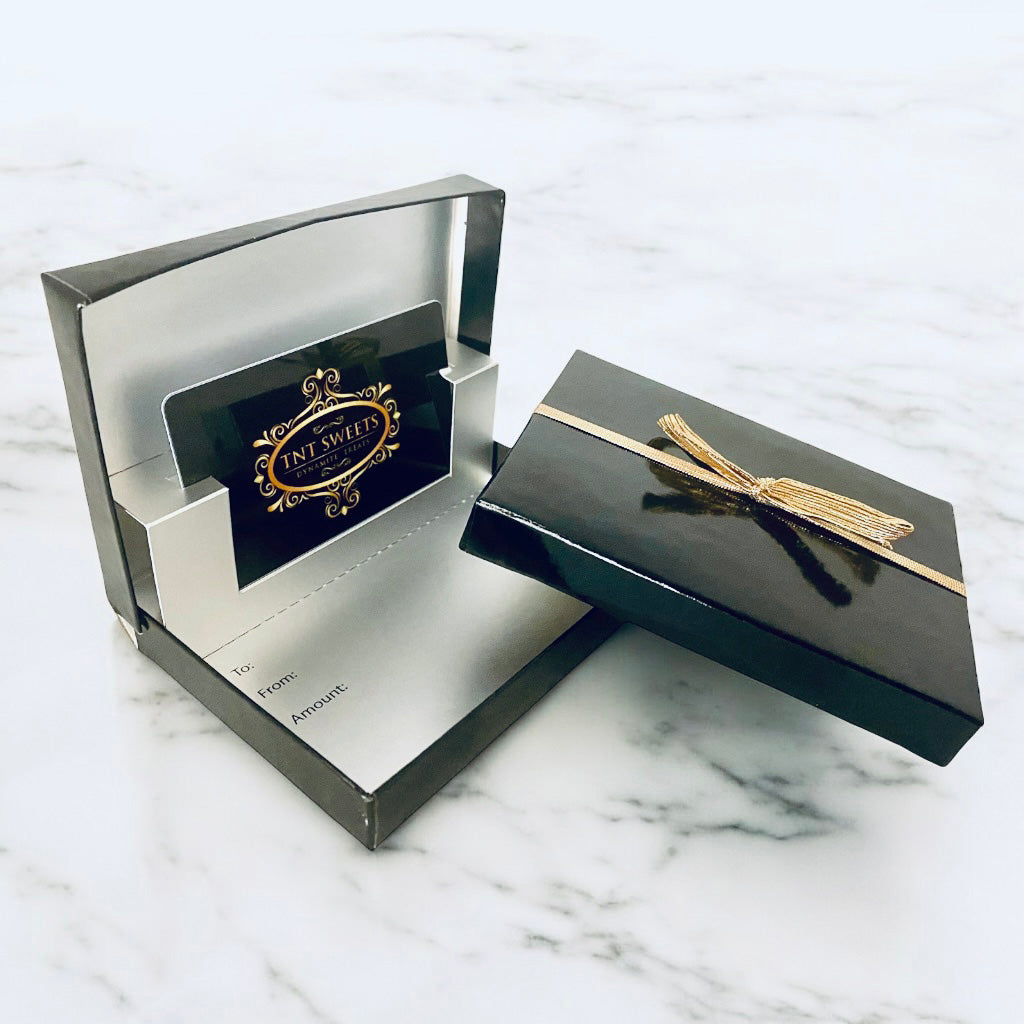 Gift card enclosed in a black glossy box on a marble countertop.