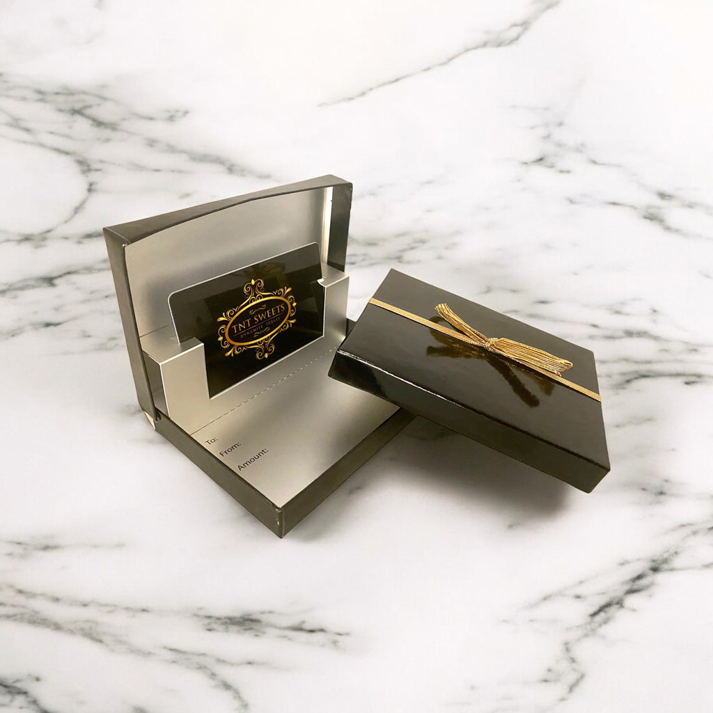 Gift card enclosed in a black glossy box on a marble countertop.