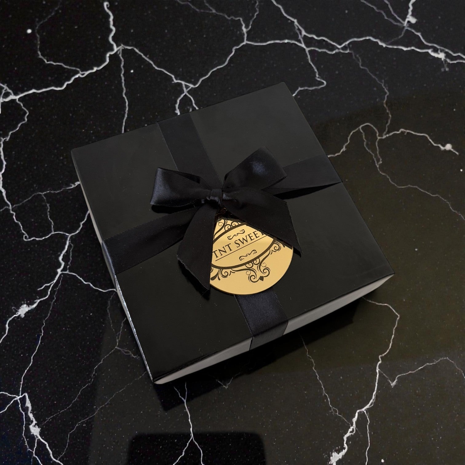 Black elegant gift box with black ribbon and gold medallion, 6x6x3.