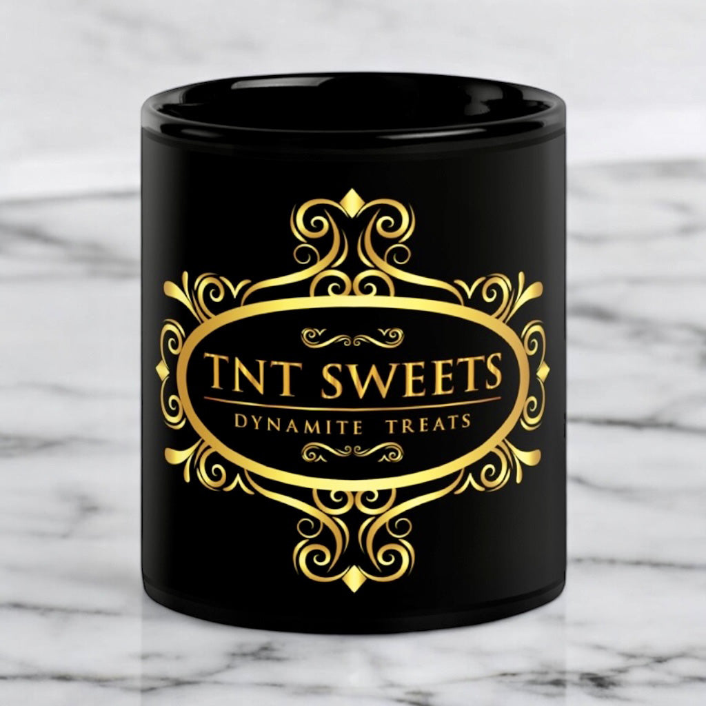 Black 11oz ceramic mug with a black logo on a white marble countertop.