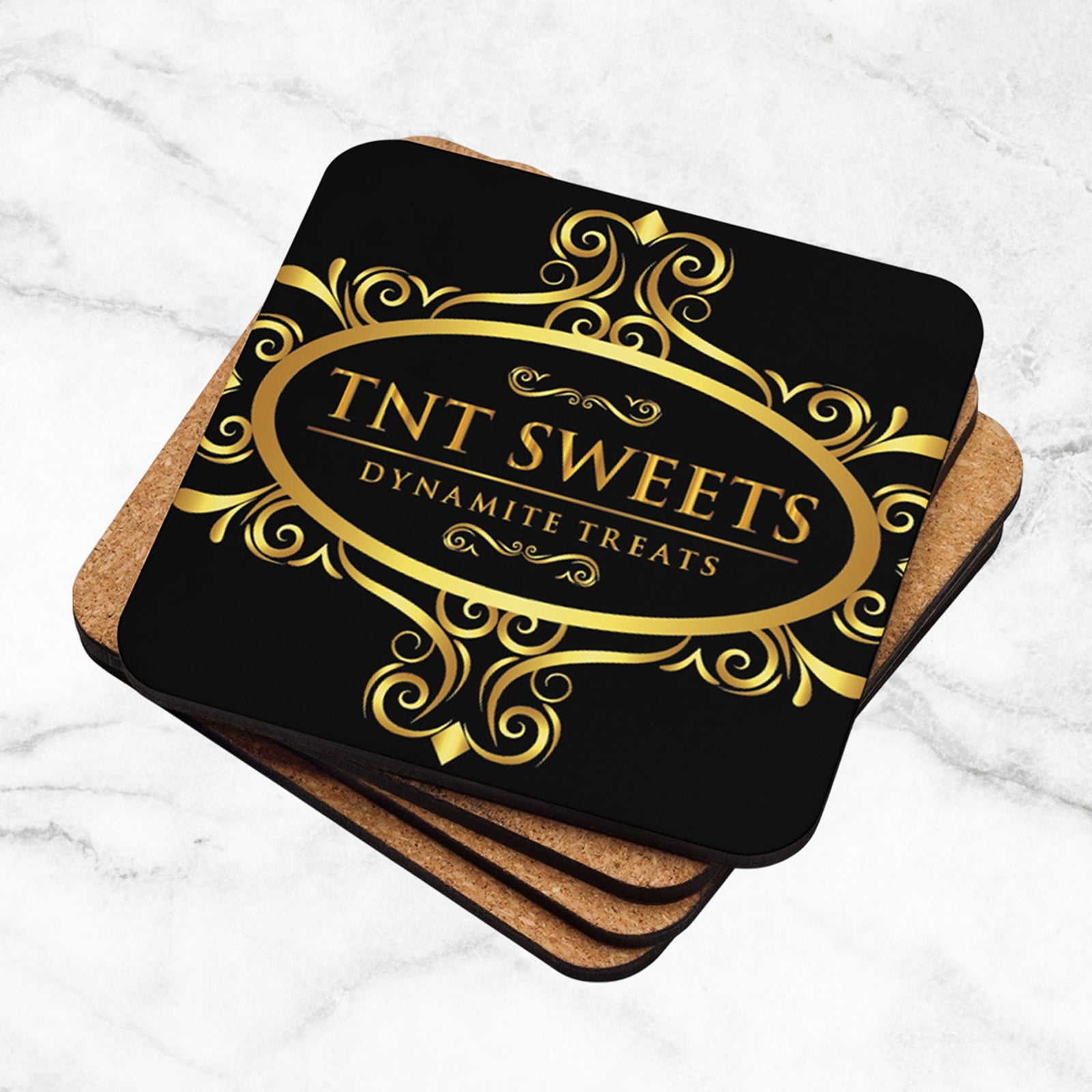 Stack of four black coasters with a gold logo on a marble background.