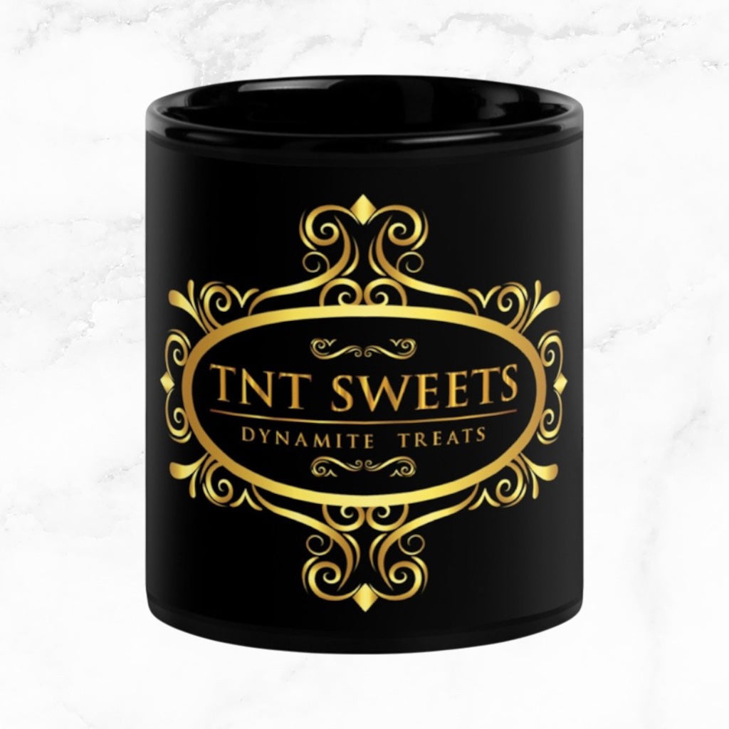 Black 11oz ceramic mug with a black logo on a white marble countertop.