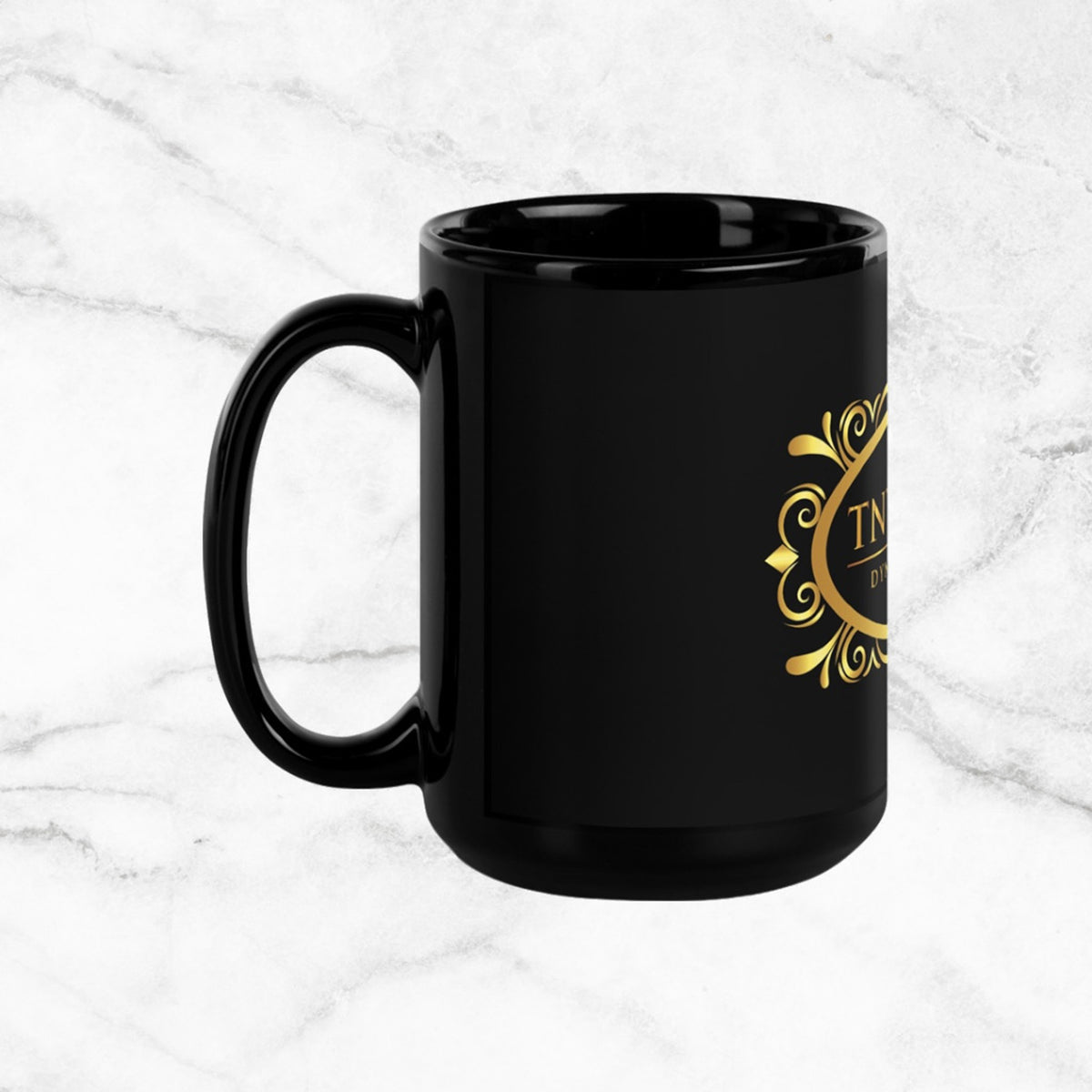 Side view Black 15oz ceramic mug with a black logo on a white marble countertop.