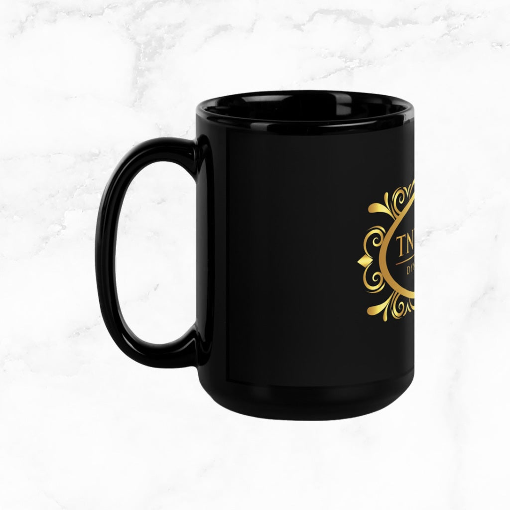 Side view Black 15oz ceramic mug with a black logo on a white marble countertop.