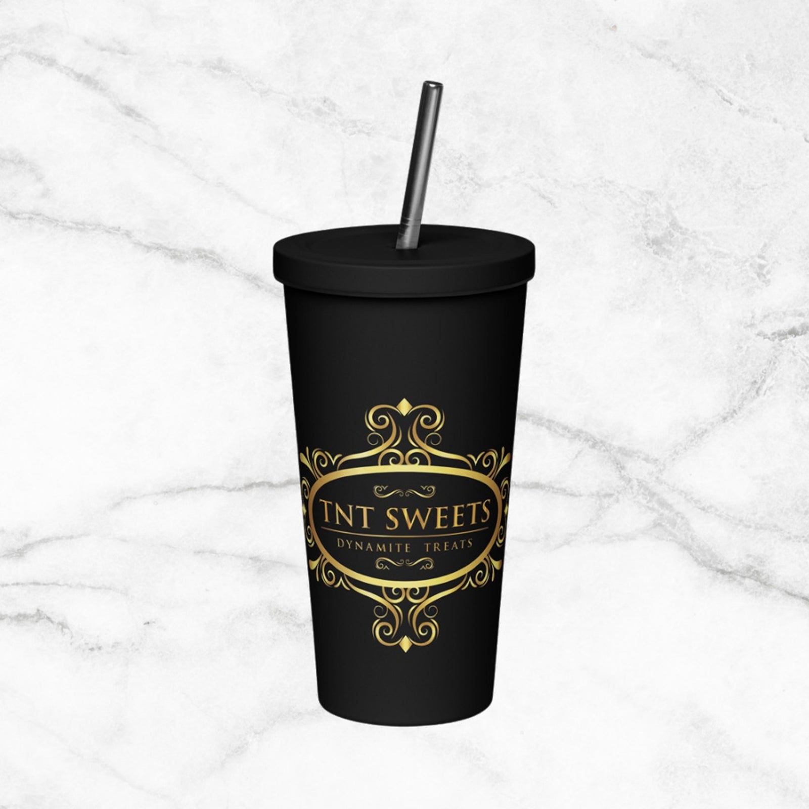Signature black tumbler with gold logo on white marble countertop.