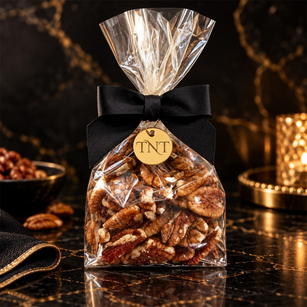 TNT Sweets half-pound pecans on a black and gold marble background.
