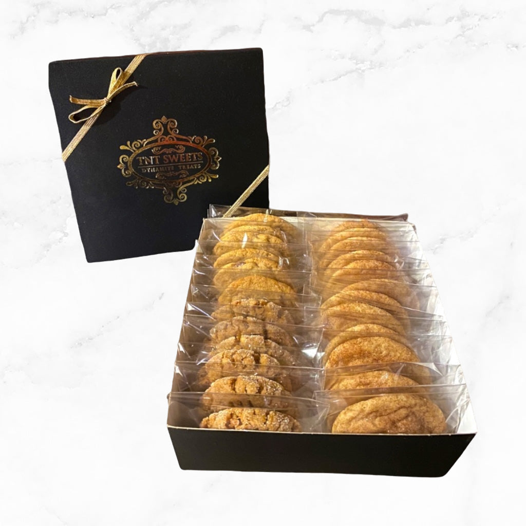 One dozen cookies assorted our signature black gift box on a marble background.