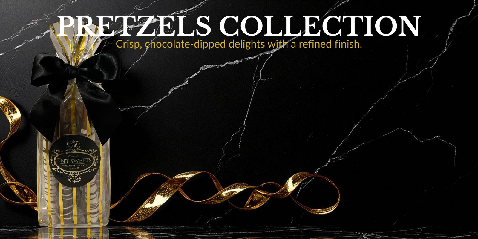 A gift bag of a chocolate-dipped pretzel medley and a gold ribbon on a black marble background of the Pretzels Collection banner page.