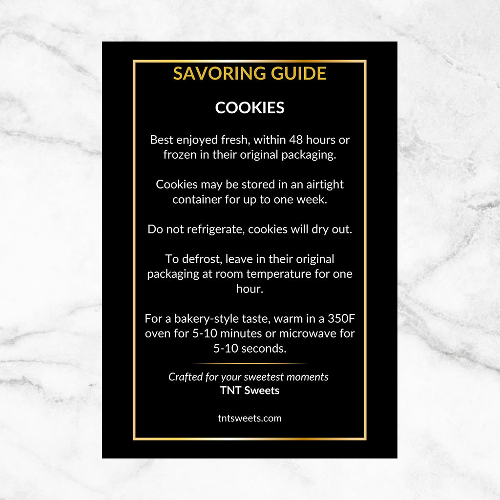 Front side of Black and gold insert cookie care instructions on a white marble background