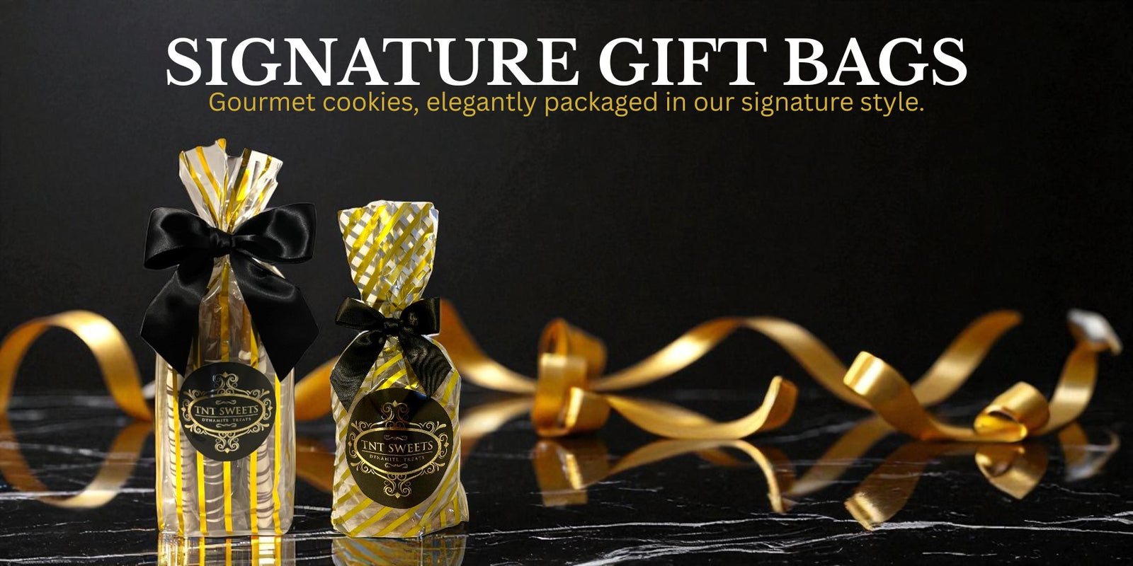 Gift bag of pretzels and a gift bag of cookies with a black marble background and gold ribbons.