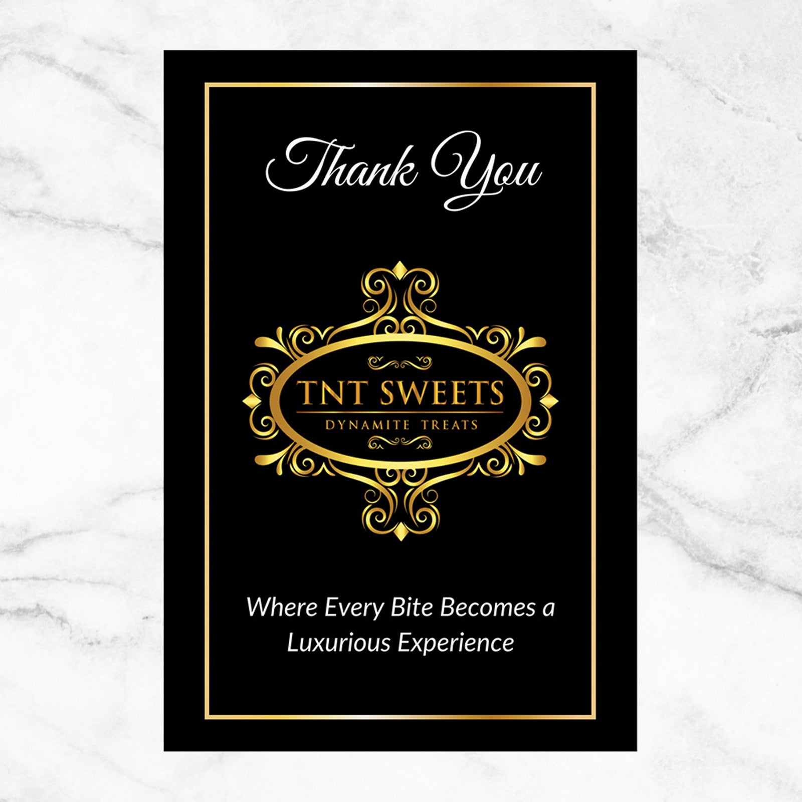 Black thank you card with gold text and 'TNT Sweets' logo on a marble background.