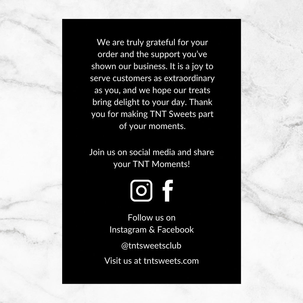 Backside of black thank you card on a marble background.