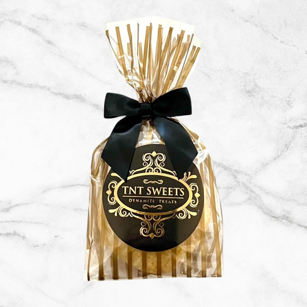 TNT Sweets Encore cookie favors presented in the Gold Stripe Wrap finished with a black satin bow and signature TNT Sweets seal.