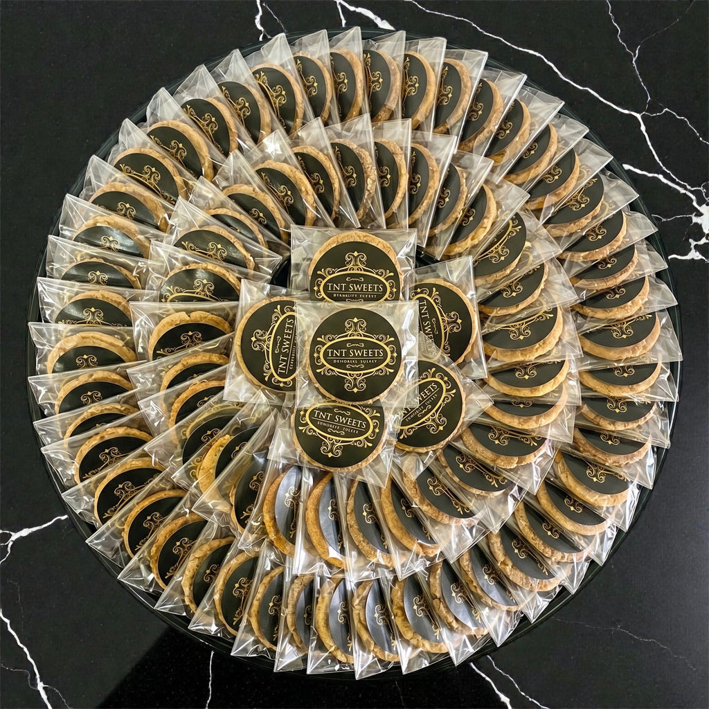 60 cookies individually wrapped on a black platter.