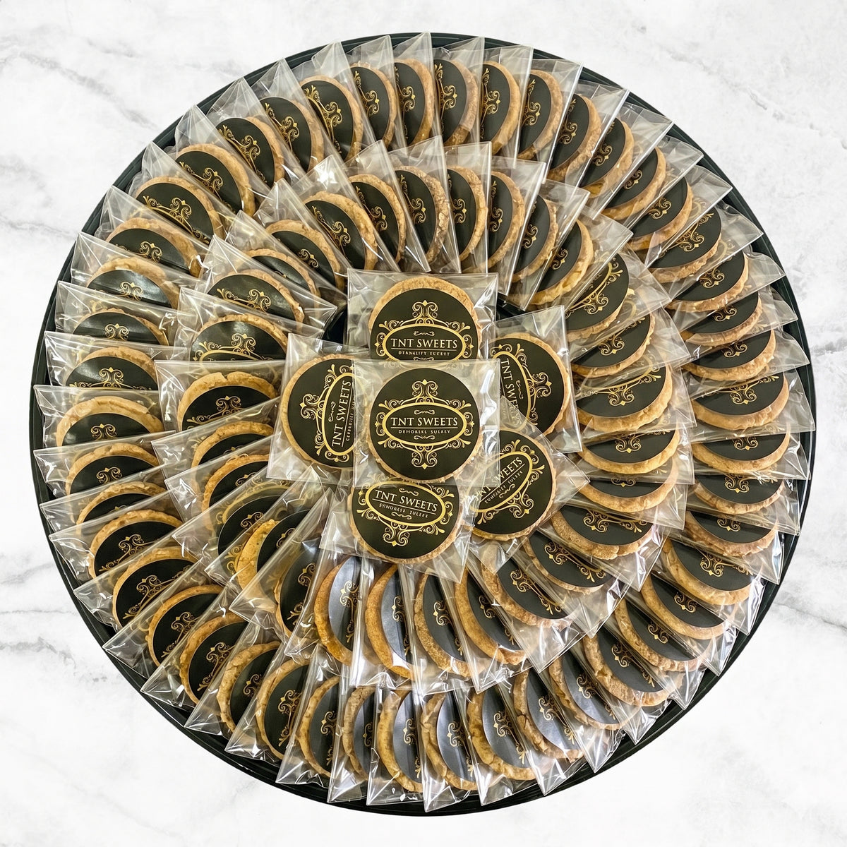 60 cookies individually wrapped on a black platter