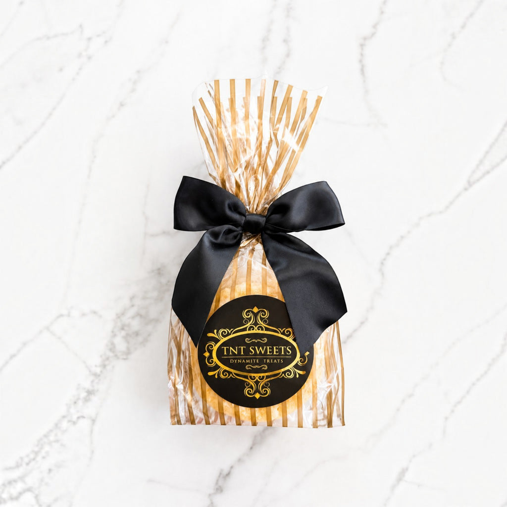 The Lumiere lemon cookies half dozen in gold stripe wrap with a black bow. 