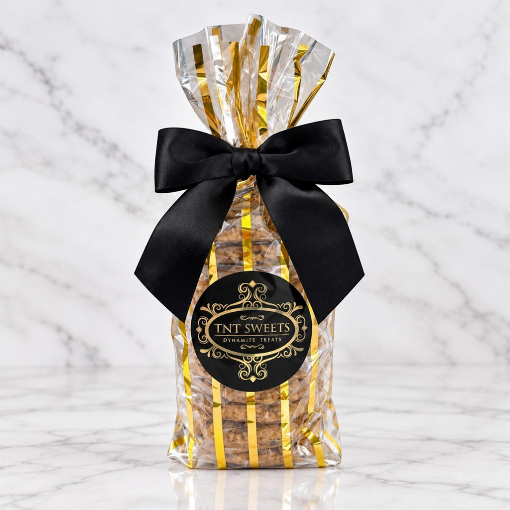 TNT Sweets, The Opus 12-piece Cookie Assortment featuring twelve artisan cookies across up to two signature flavors, presented in the Gold Stripe Wrap with a black satin bow and Signature TNT Sweets seal.