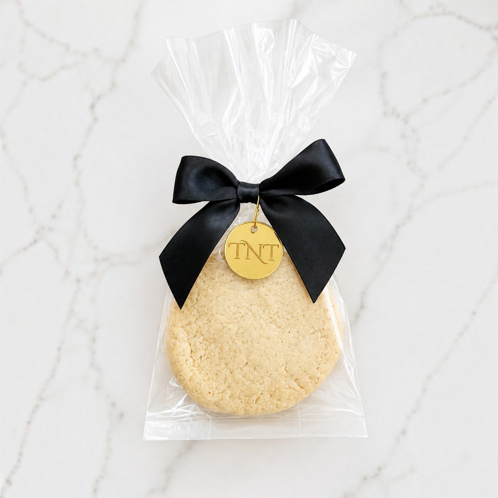 The Première vanilla bean shortbread cookie favor with black satin ribbon.