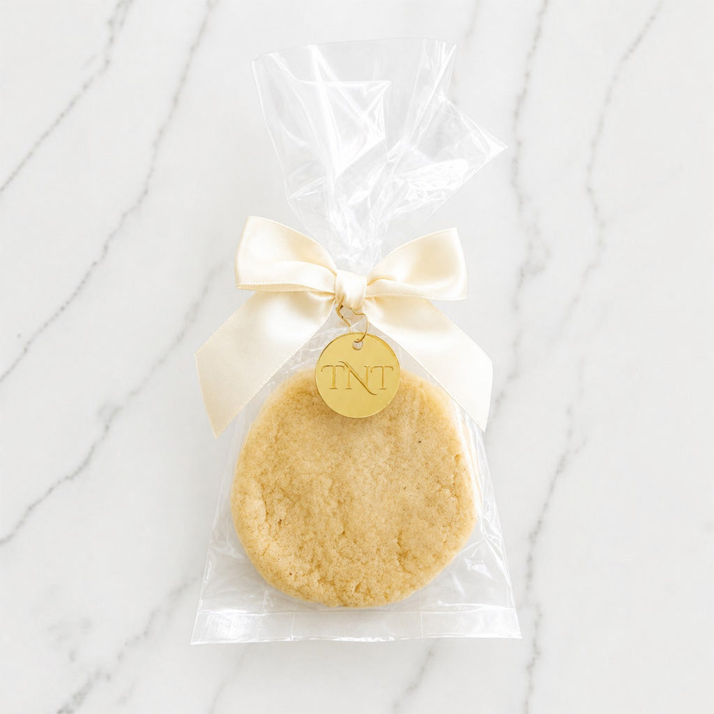 The Première vanilla bean shortbread cookie favor with ivory satin ribbon.