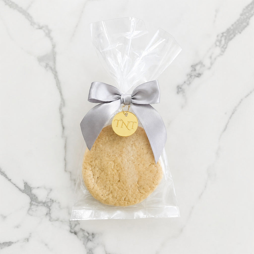The Première vanilla bean shortbread cookie favor with silver satin ribbon.