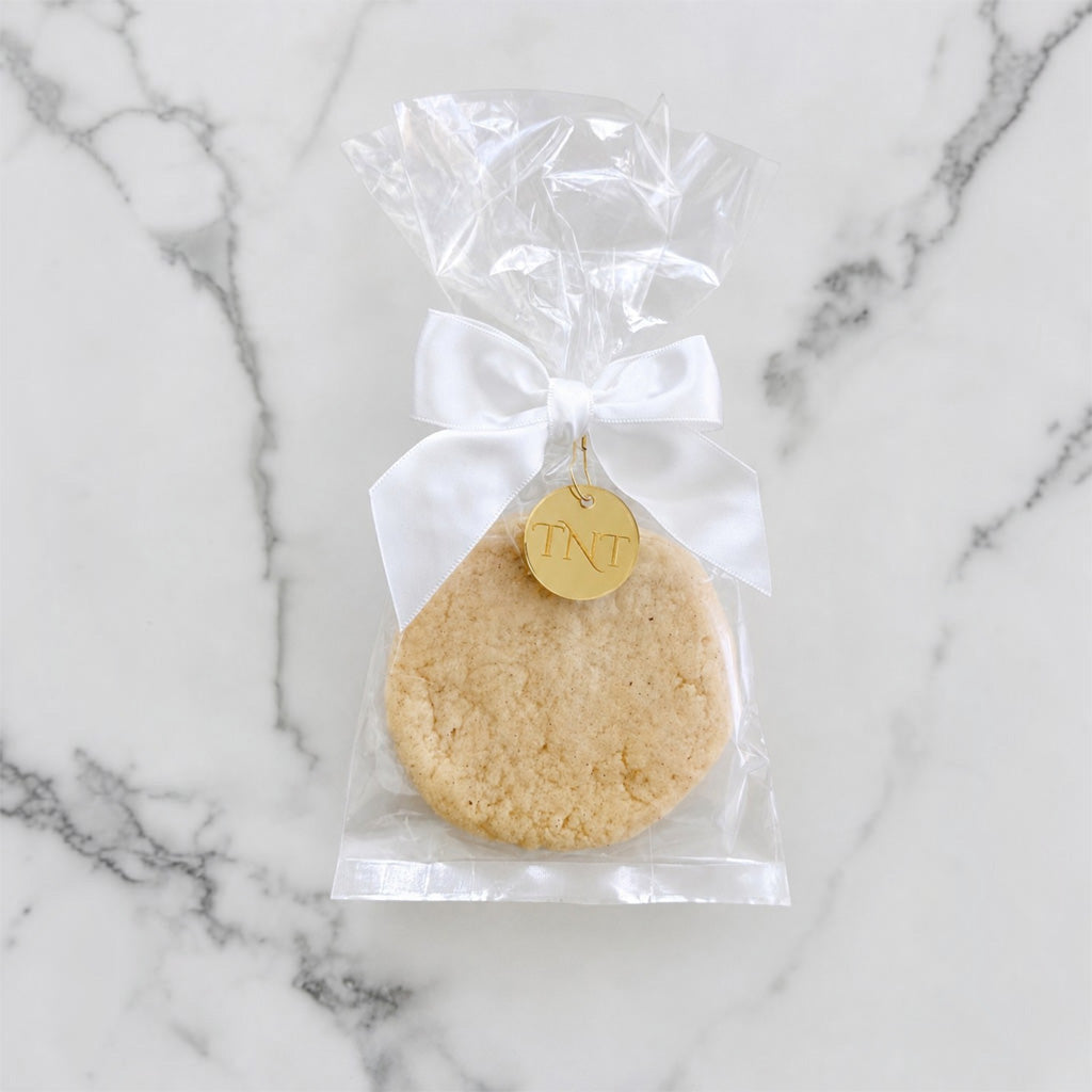 The Première vanilla bean shortbread cookie favor with white satin ribbon.