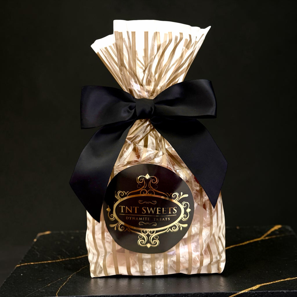 The Velvet Heat caramels from TNT Sweets in the Gold Stripe Wrap tied with a black satin ribbon finished the TNT Sweets signature seal. 