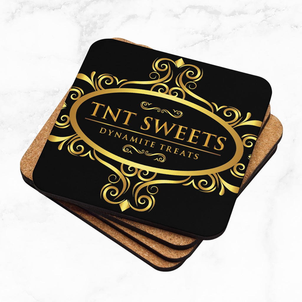 Stack of four black coasters with a gold logo on a marble background.