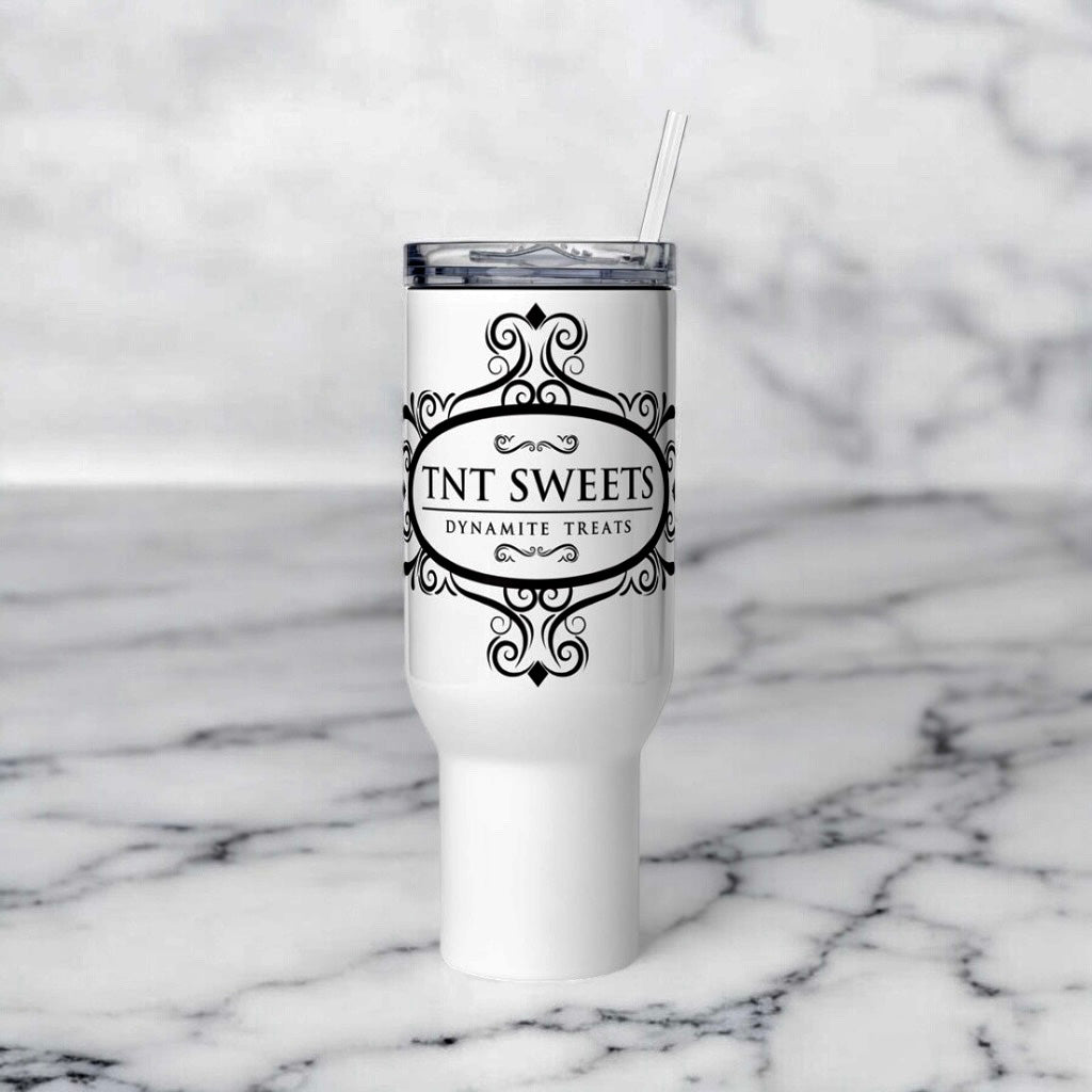 White tumbler with TNT Sweets Dynamite Treats logo on a white marble background.