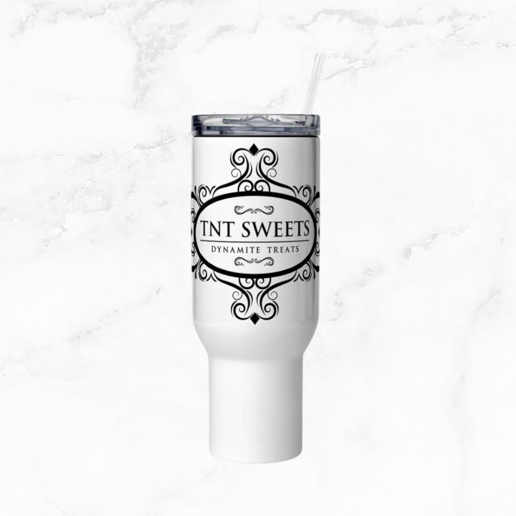 White tumbler with TNT Sweets Dynamite Treats logo on a white marble background.