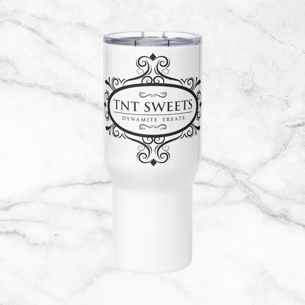 White Travel with mug with black TNT Sweets logo on a marble background.