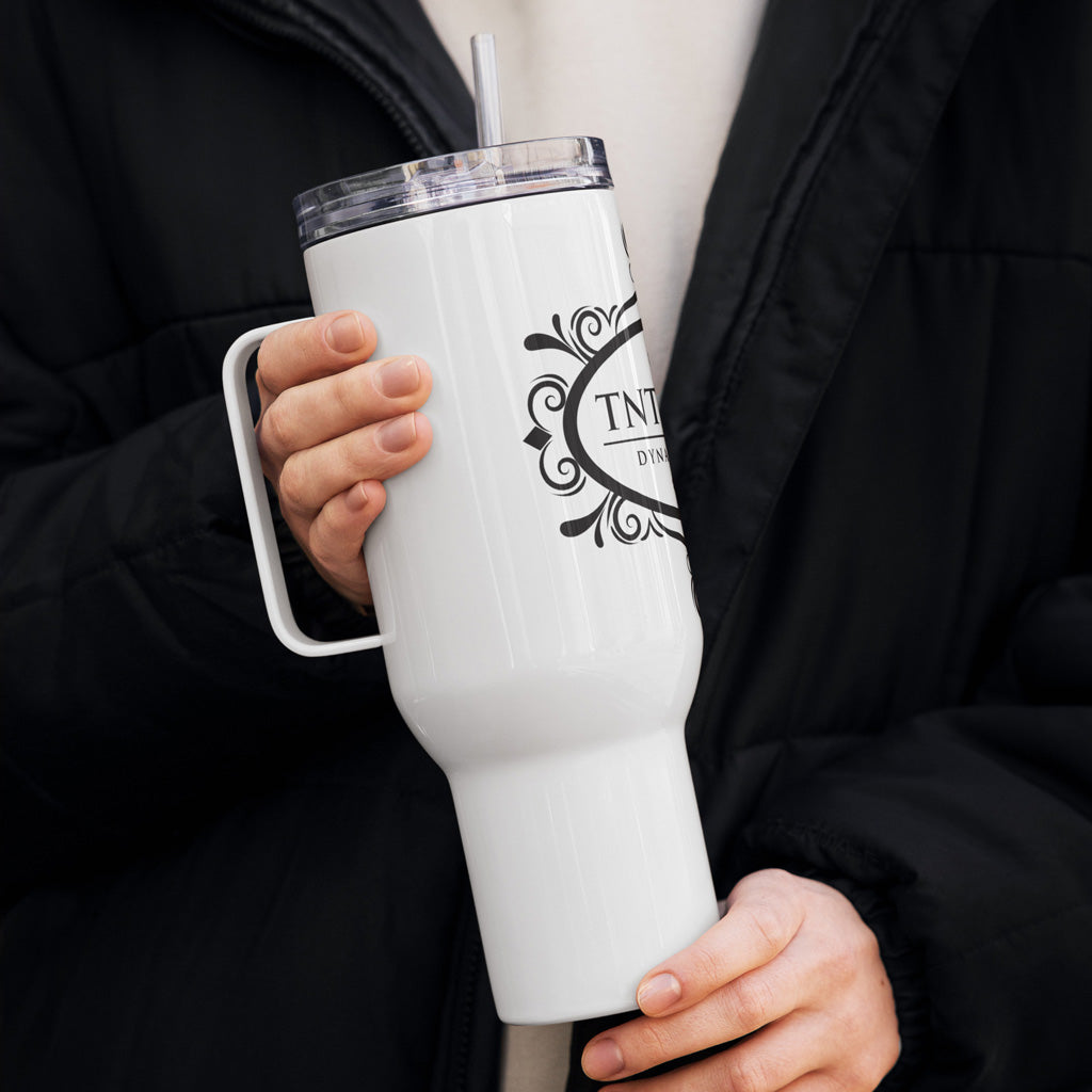 Person holding white 40oz travel mug. 