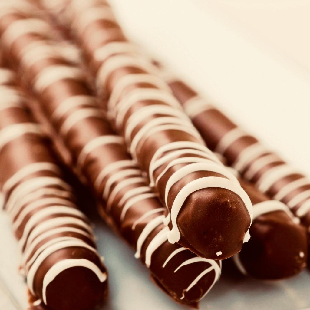 Stack of dark chocolate pretzels with a blurred background.