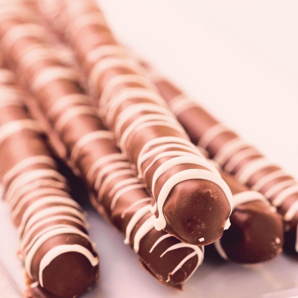 Stack of milk chocolate pretzels with a blurred background.
